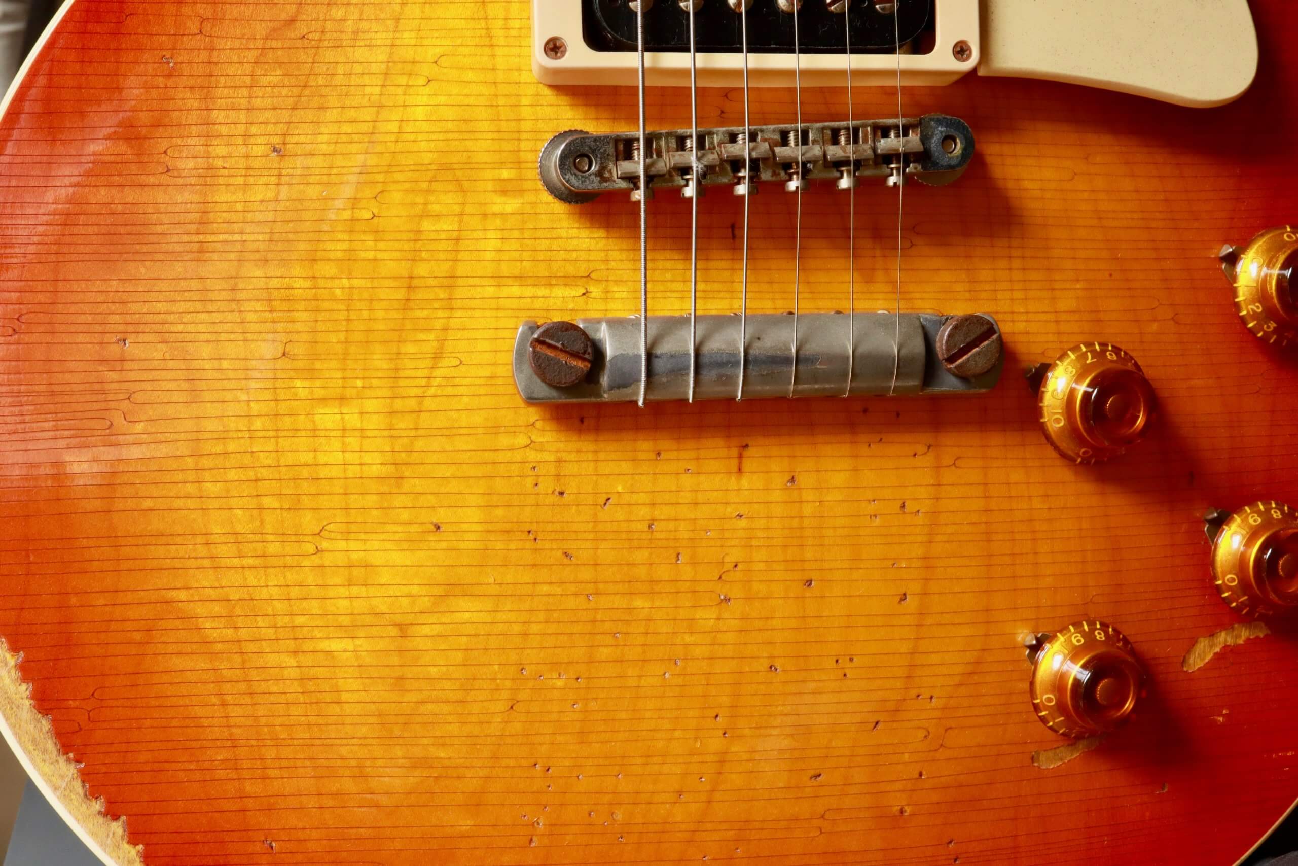 Extreme closeup of a guitar with a sunburst finish