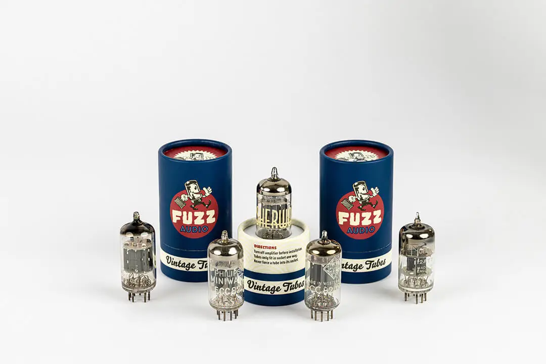 Set of vintage tubes and packaging against a gradient white background